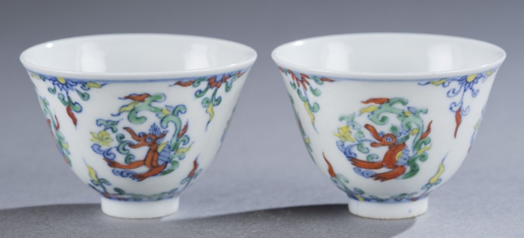 Ching Doucai wine cups.: A pair of Ching Dynasty Doucai wine cups. Porcelain. Decorated with dragons. Marked on bottom with 6 character Ming Chenghua mark.1 5/8"h x 2 1/2"diam.