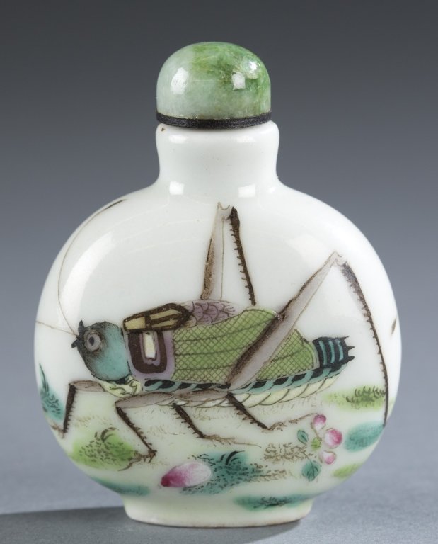 A Chinese porcelain famille verte snuff bottle.: A Chinese porcelain famille verte snuff bottle. c.1821-1850. Of rounded form with an oval foot rim and design of grasshopper and flowers on front and back with a cabochon green hardstone stopper. 2 1/