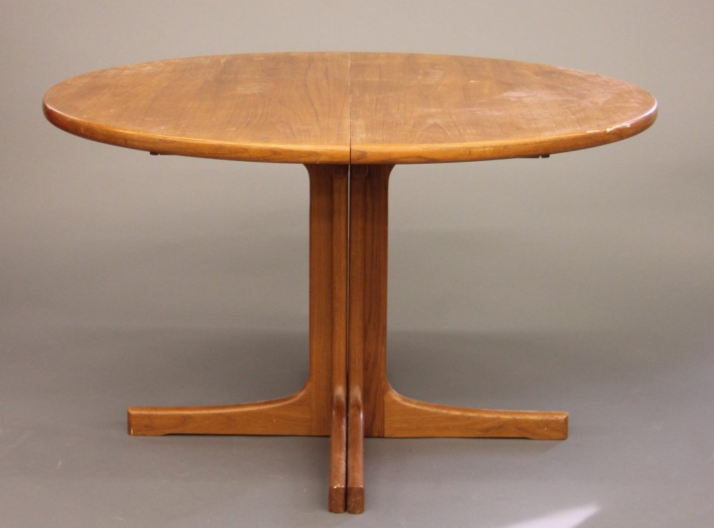 A Niels. O. Moller teak dining table.: A Niels. O. Moller teak dining table. 1960s. Teak dining table with sculpted legs and an expansion leaf. 28 1/2"h x 47 1/2"; leaf: 11 3/4"w x 47 1/2"d.