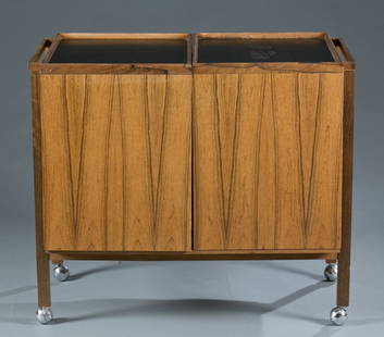 A Niels Erik Glasdam Jensen bar cart.: A Niels Erik Glasdam Jensen bar cart for Vantinge Mobelindustri, Denmark. 1960s. Rosewood, melamine, laminate and glass. Opens to reveal a glass shelf a 2 sliding doors. On casters. 28 3/4"h x 33 1/2"