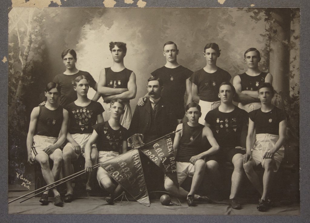 2 Albumen photos c. 1903 CBOAA Track & Field Teams: [Track & Field]. 2 Mounted Albumen photographs of a college or high school track and field team, posing with hammer throw ball and relay race pennant. ++ 10 members of track and field team, likely col