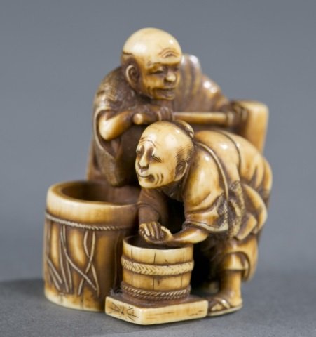 An ivory netsuke of two men making Mochi. (1 of 4)