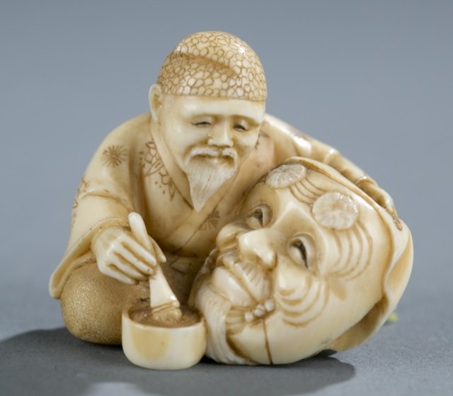 A Japanese ivory netsuke of a Noh mask painter. (1 of 5)
