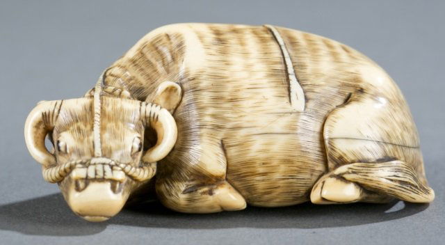 A Japanese ivory netsuke of an ox. (1 of 5)