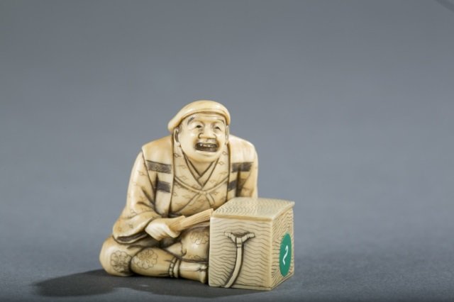 A Japanese ivory netsuke of a performer. (1 of 5)