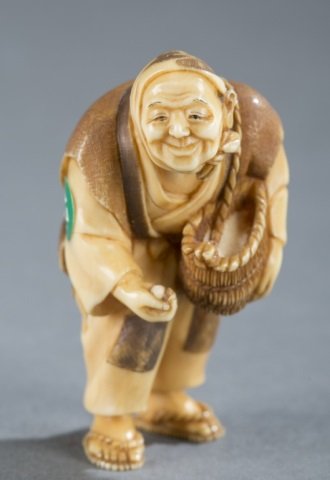 A Japanese ivory netsuke of a farmer. (1 of 6)