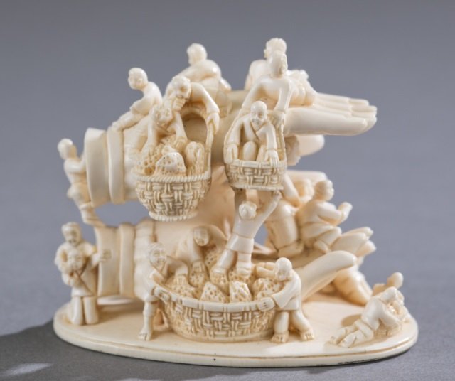 A small ivory carving of Buddha hands w/figures. (1 of 4)