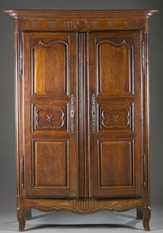 Louis XV French armoire.: A Louis XV French armoire. With 3 blind panel doors, center panel with raised 5 point star, 4 interior shelves, cabriole legs, peg construction,and iron strapwork escutcheons. 83"h x 50"w x 23 1/4"d. 