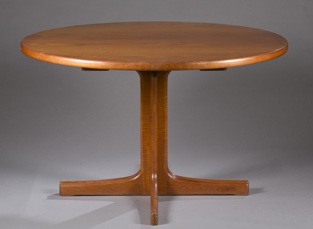 Niels. O. Moller teak dining table.: A Niels. O. Moller teak dining table. 1960s. Teak dining table with sculpted legs and 2 expansion leaves. 29"h x 47"diam (closed);each leaf: 23 1/2"w.