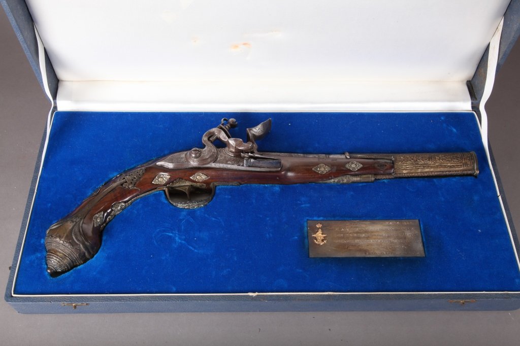 Presentation Pistol-Greek to Gen. Maxwell Taylor: A Greek flintlock pistol. 19th century. Presented to General Maxwell Taylor, 1963. Illegible proof marks. In presentations case with inscribed plaque. Gun: 16 1/2"long. Case: 3"h x 18 1/4"w x 8 3/4"d.