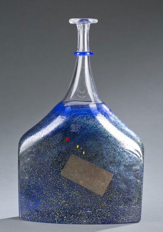 A large Kosta Boda vase by Bertil Vallien.: A large Kosta Boda vase by Bertil Vallien. Large vase in the shape of a perfume bottle in shades of blue with light green and specks of red and orange. Kosta Boda label, etched on bottom, "KOSTABODA,