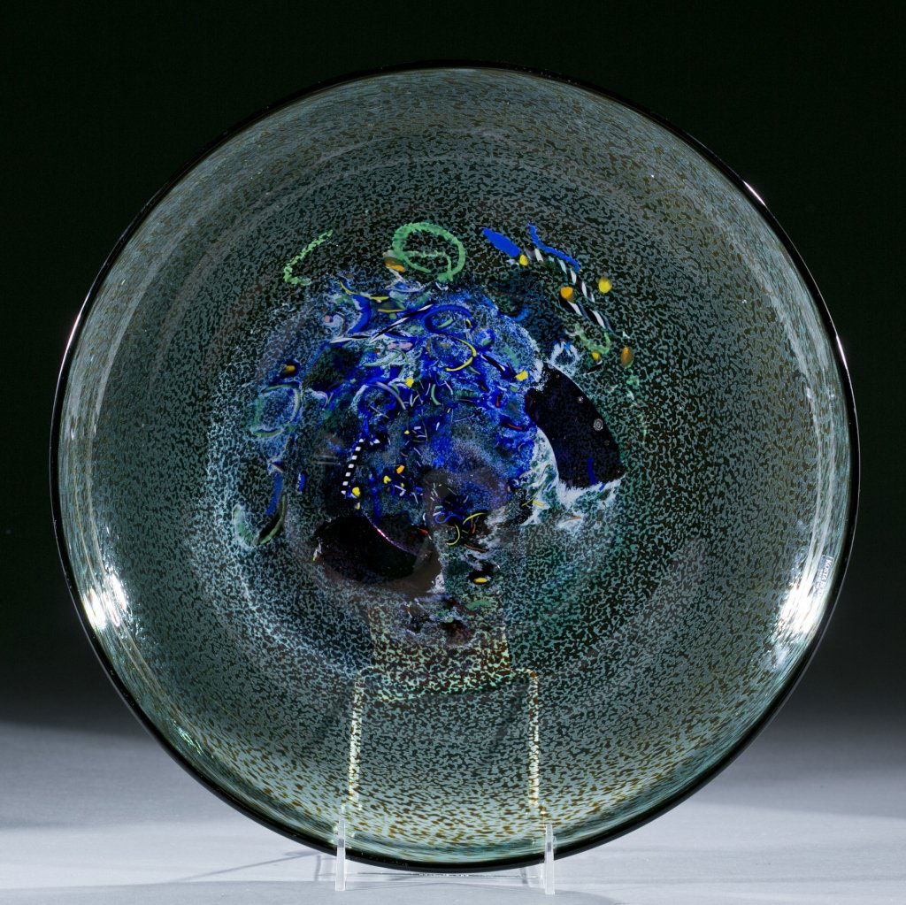 Kosta Boda bowl by Bertil Vallien: A Kosta Boda bowl by Bertil Vallien. "Meteor" in greens and blues with accents of yellows and reds. On bottom, inscribed "Kosta Boda, Bertil Vallien, 79231". Original Neiman Marcus sticker and Kosta B