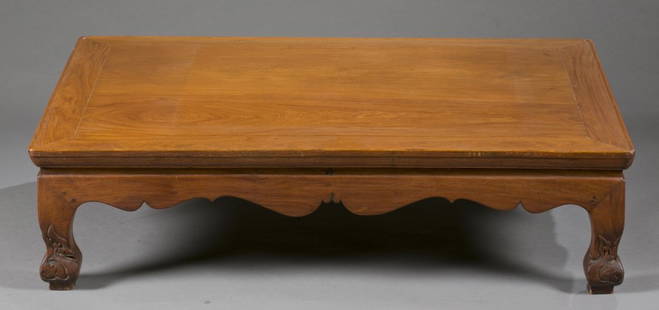 A Chinese rosewood Kang table.: A Chinese rosewood/ Caohuali Kang table. Late 19th-early 20th century. "S" shape legs with floral carvings on the feet. 11" x 42" x 28".