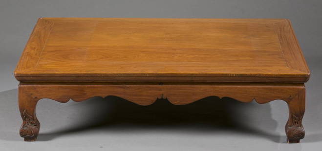 A Chinese rosewood Kang table.: A Chinese rosewood/ Caohuali Kang table. Late 19th-early 20th century. "S" shape legs with floral carvings on the feet. 11" x 42" x 28".