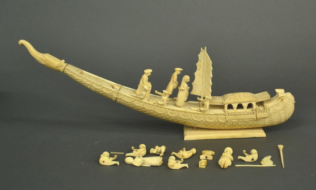 An India/Indonesia ivory tusk phoenix boat.: An India/ Indonesia ivory tusk phoenix boat with 21 pieces. Circa late 19th century. Missing the boat head and partial decorative pieces. 13". Bidders should be aware of the changing laws regarding co