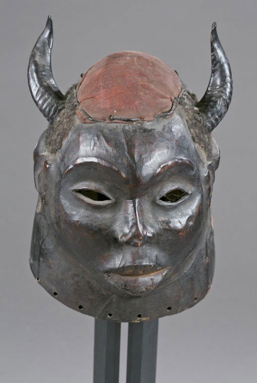 A skin covered horned helmet mask. 20th c. (1 of 3)