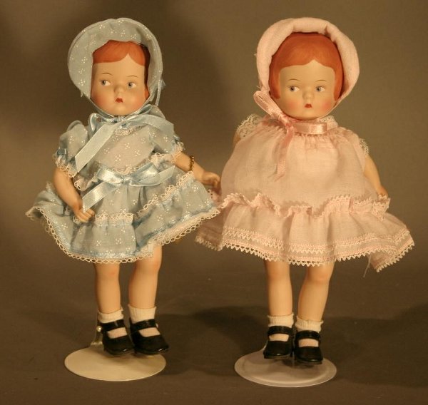 Modern Effanbee Porcelain Patsy Dolls. One blue dr: Modern Effanbee Porcelain Patsy Dolls. One blue dress, one pink. Measures 9.5" tall.