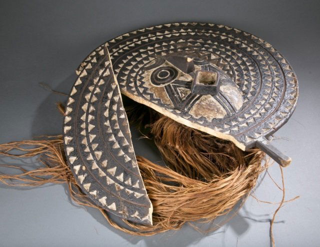 Polychrome and wooden circular face mask. (1 of 4)