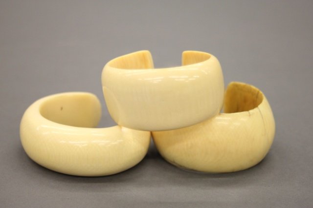 Group of 3 small African ivory cuff bracelets.: A group of three small ivory cuff bracelets. Circa 19th century. One with multiple old repairs. Inner diameter: 1 3/4" - 2 1/4". Outer diameter: 2" - 3". Bracelet width: 1" - 1 1/2". Bidders should be