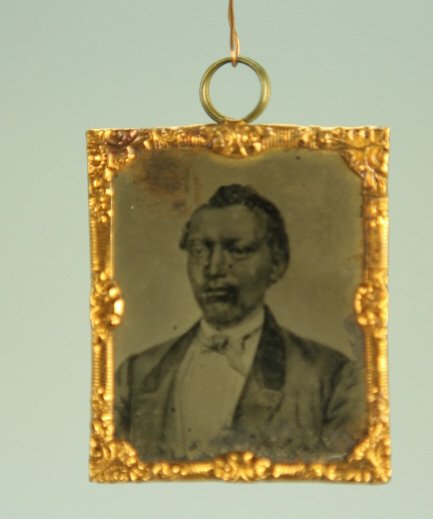 Very Rare WILLIAM TILLMAN Tintype by Abbott of NY: [Photograph/Tintype] William Tillman tintype by Abbott & Co. showing a head and chest image of Tillman dressed in a suit and soft tie. Copper trim around tintype, 1 1/2 in. x 1 1/4 in., reverse w/ tex