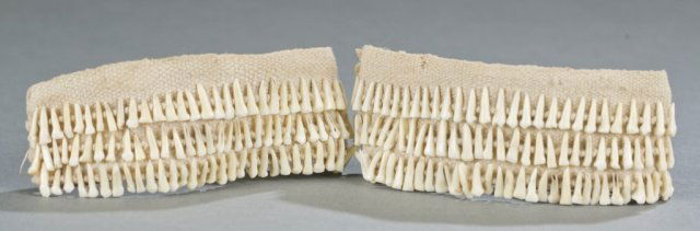 Pair of monkey tooth anklets.: A pair of monkey tooth anklets. 1 5/8"h x 4 1/2"w.
