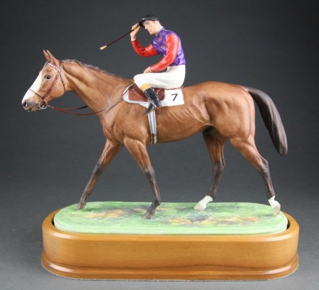 Royal Worcester "The Winner" c.1959.: A Royal Worcester bone china figurine of "The Winner" modeled by Doris Lindner c. 1959. Marked on base. To include wooden plinth base. 11" h x 10" l x 4 1/2" w.