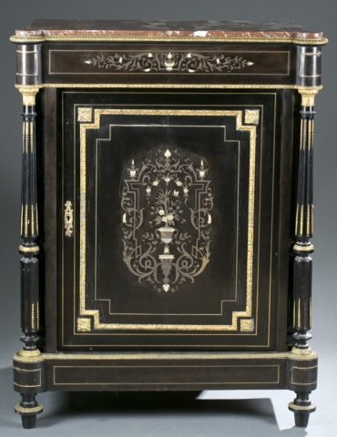 Empire Boulle marquetry cabinet, 19th century.: An Empire Boulle marquetry cabinet. French. 19th century. Ebonized wood body with single blind door, gilt bronze mounts, inlaid brass, mother of pearl, and bone, capped columns on either side of door,