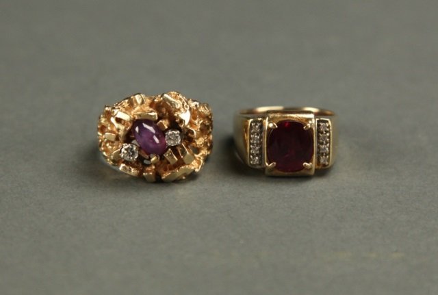 Group of 2 red stone rings.: Two red stone rings. One nugget style mounting is set with an oval synthetic ruby star sapphire and two diamonds, combined weight 0.24 carats. The retro style mounting is set with an oval red spinel a