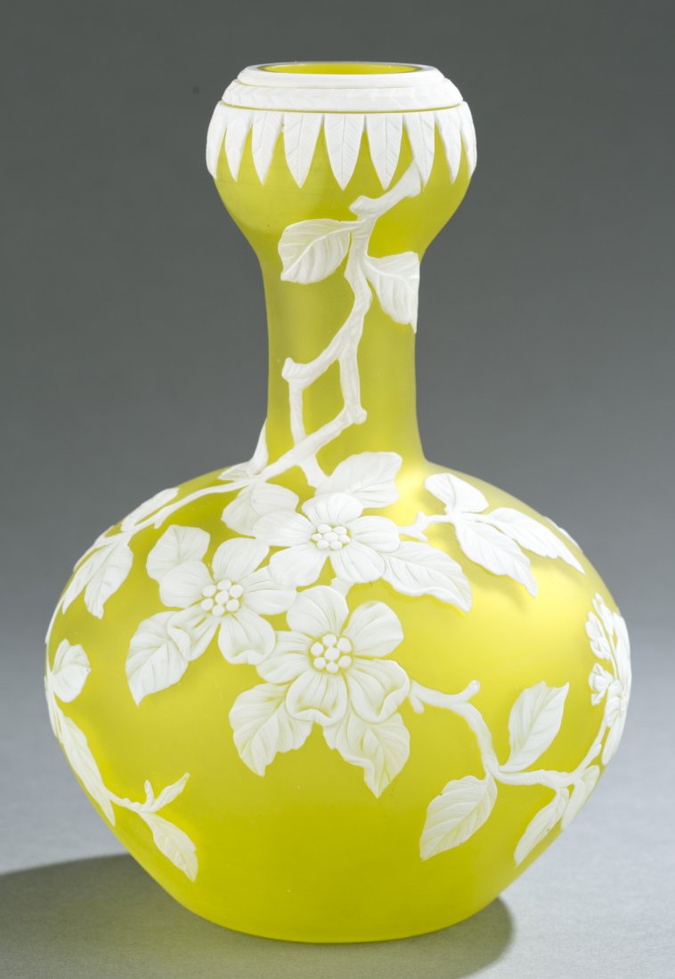 Cameo art glass vase, Webb style, 19th c.: An cameo art glass vase, unmarked. In the style of Thomas Webb & Sons. English. Late 19th century. Garlic bulb vase shape with green body and cut white overlay of peach blossoms on branches and repeat