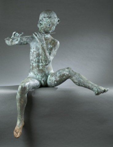 Peter Pan patinated metal sculpture.: A patinated metal garden sculpture of seated figure of Peter Pan or a boy playing a flute. Unsigned. 20th century. Approx. 49" x 45 3/4"w x 24"d.