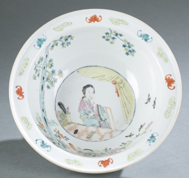 Chinese enamel painted porcelain wash basin.: A Chinese enamel painted porcelain wash basin. Late Qing dynasty. Decorated with a lady siting near the window scene, with flower, bird and bat motifs. 3 1/2"h x 10 13/16"dia.