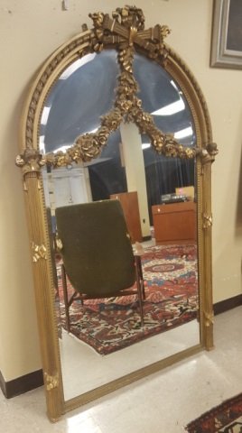 French Louis XVI style gilt wood pier mirror.: A Louis XVI style gilt wood pier mirror. French. 19th century. With gilt carved wood swags at top. 74 1/2"h x 46"w x 4 3/4"d.