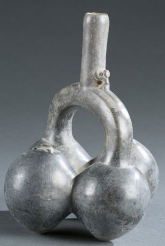 Chimu style stirrup vessel, seed pods. c.20th cen.: A Chimu style ceramic stirrup vessel in the shape of seed pods. North Coast Peru. c.20th century. 8 3/4"h x 7"w x 7"d. Please note that unless stated stands do not come with pieces.