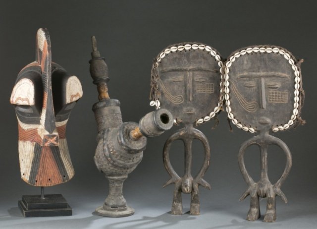 4 West & Central African objects.: A group of 4 West & Central African objects. c.20th century. ++ Kifwebe mask. DRC, Songe. ++ West African bone, ceramic, and wood pipe. ++ Pair of standing wood male and female figures with cowre shel