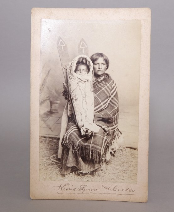 Sawyer's Indian Art Photo: Kiowa Squaw & Cradle: [Photography/Sawyer's Indian Art Gallery]. Very rare boudoir photograph titled "Kiowa Squaw and Cradle" in photo with imprint on verso: "W.L. Sawyer's Indian Art Gallery/Purcell/Indian Territory" foll