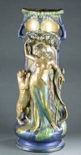 Art Nouveau luster ceramic umbrella holder.: An Art Nouveau figurative luster ceramic umbrella holder. Continental. Possibly Austrian. With Bacchant figure holding grapes and a pinecone staff with a rearing lioness below grapevines. 30"h x 12"di