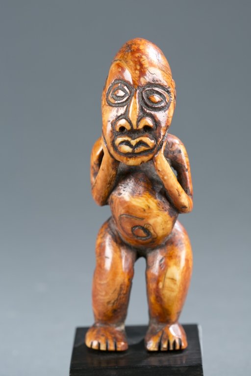 A standing ivory figure. (1 of 3)