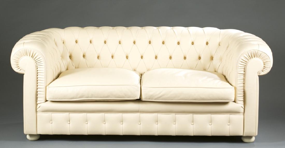 Renzo Frau Italian cream leather loveseat.: A Renzo Frau cream tufted leather loveseat retailed by Poltrano Frau. 27 1/2" x 68" x 32".