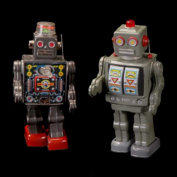 Two 1950's Japanese Tin Action Robots: Two Japanese Tin Action Robots circa 1950 approx. 11 1/2" x 5 1/2" in good working condition(witth the exception of the arms), no battery damage, one robot with rotating torso
