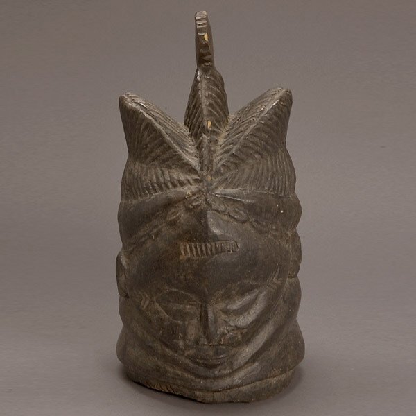 1/2 SCALE MENDE BUNDU HELMET MASK AFRICAN ART: HALF-SCALE MENDE BUNDU HELMET MASK. Perhaps a model, carved halfway inside. Classic form of the type, roughly cut. Liberia/Sierra Leone. 20th century. 12 1/4 x 6 x 6 1/2 inches. In very good condition