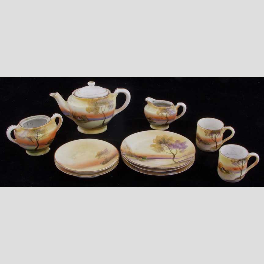 Partial child's tea set, "Autum River Sc: Partial child's tea set, "Autum River Scene" Consisting of teapot, sugar (without lid), creamer, two cups, two saucers, and three side dishes. Stamped on bottom:NoritakeHand Painted Made in Japan One