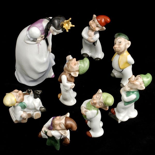 Herend Snow White and Seven Dwarfs: Set of Herend Figures of Snow White and the Seven Dwarfs, Circa 1940, the bent crowned Snow White looking down at the dwarfs raising her right hand to count them, her left arm lifting her skirt Herend