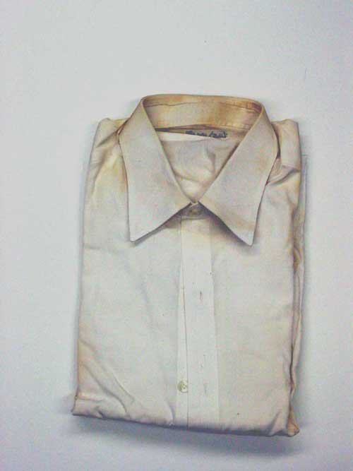John F. Kennedy dress shirt: John F. Kennedy's Dress Shirt. White cotton with French cuffs, label Brioni Roma, dry cleaning label and collar stay, cotton yellowing and some pinpoint spots. Property of M. B. Gallagher.