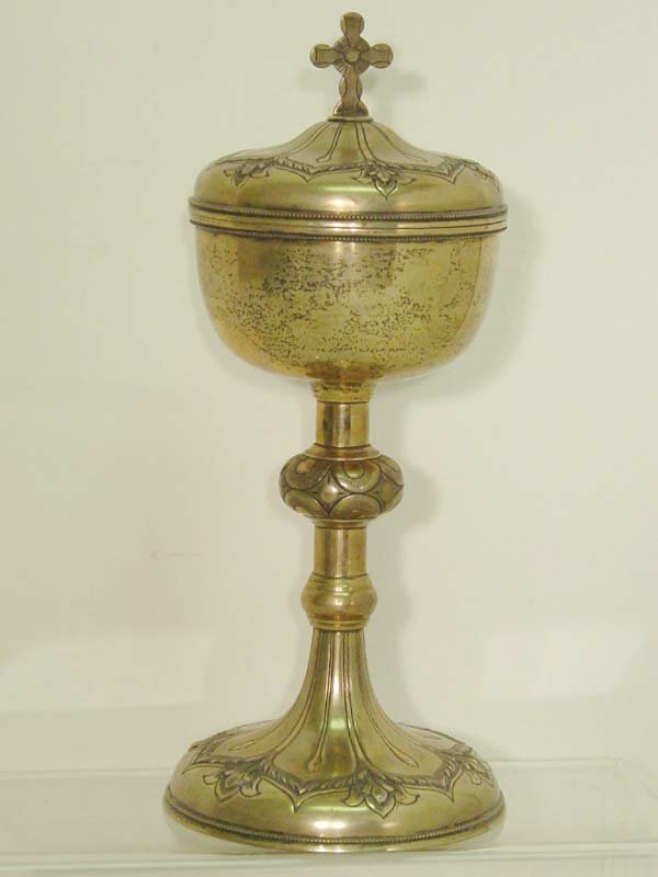 Jenkins & Jenkins Silver Chalice: Baltimore Sterling Silver Chalice and Cover. Circa 1915. Mark Jenkins & Jenkins. Foliate-engraved domed top surmounted by a cruciform finial, similarly engraved bowl, with vermeil interior, geometric