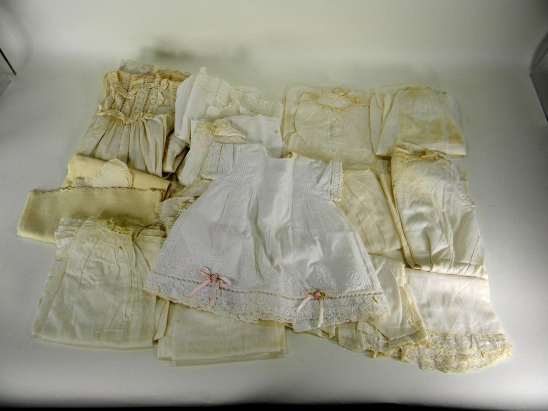 Assorted antique baby clothes.