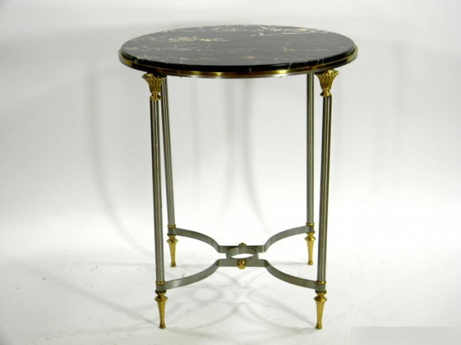 STEEL AND BRONZE GUERIDON: French Mid-Century steel and bronze guerdon table with black marble top. Height 26 x diameter 22 1/2 inches.