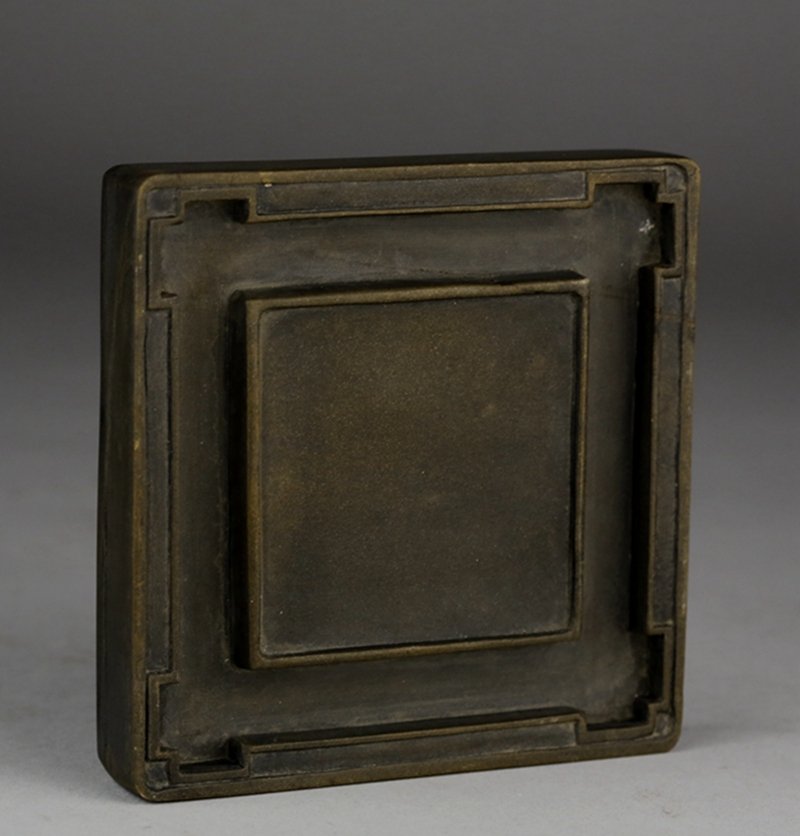 A SQUARE DUAN INKSTONE: Ming or Qing period. A square duan inkstone. 明/清井形绿端砚台 D: 10.5cm; H: 1.8cm.
