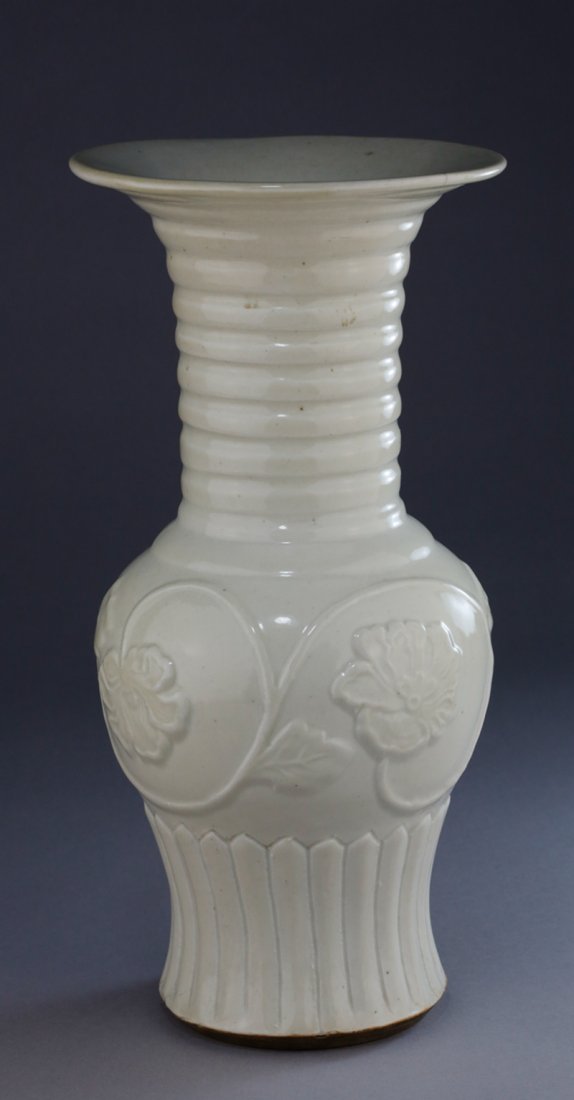 END OF YUAN/ EARLY MING WHITE PORCELAIN 'LOTUS' VASE: End of Yuan or early Ming period baluster shaped vase, decorated with high relief carvings of lotus and vines between horizontal bands on neck and plantain leaves on foot. 元末明