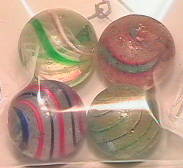 65042 BB Marbles: 4 Latticinio Swirls: SWIRL, Latticinio core. Lot of four marbles. Variety of colors. 25/32" to 13/16". Near Mint(-) to Good.