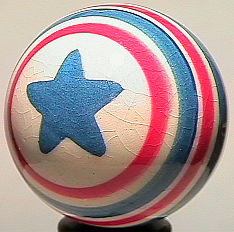 73238 BB Marbles: Tom Thornburgh Circus Ball: CONTEMPORARY HANDMADE, Tom Thornburgh. Handmade, handpainted china.Circus Ball. White background. Blue star on either pole. Red and blue lines around equator.Nicely made. Unsigned. 1-1/16". Mint (9.9)